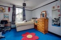 Childs blue bedroom with flower rug