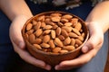 Childs delight close up of a hand holding a bowl, almonds within