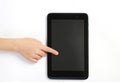Childs finger showing on tablet on white background