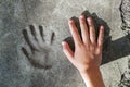 Childs hand and memorable handprint in concrete