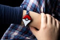 Childs hand with new Japanese game Pokemon go plus made by The Pokemon company Nintendo.