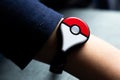 Childs hand with new Japanese game Pokemon go plus made by The Pokemon company Nintendo.