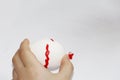 Childs hand paints an Easter egg with a brush Royalty Free Stock Photo