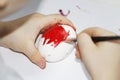 Childs hand paints an Easter egg with a brush Royalty Free Stock Photo