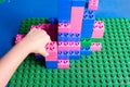 Childs hand while playing lego blocks Royalty Free Stock Photo