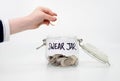 putting coin into swear jar Royalty Free Stock Photo