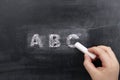 Childs hand writing ABC on blackboard Royalty Free Stock Photo