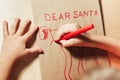 Childs hands drawing letter to Santa close up