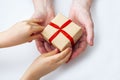 Childs hands give gift box to grandmother. Congratulations with present for mothers day or National Senior Citizens Day. World Royalty Free Stock Photo