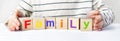 Childs hands hold cubes with the colorful alphabet made the word family on the surface of a table. The caring, parenting, trust Royalty Free Stock Photo