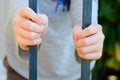 Childs hands holding bars