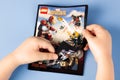 Childs hands open comic book Lego Marvel Super Heroes