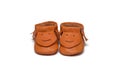 Childs orange booties on a white background