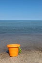 Childs orange bucket at the beach