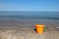 Childs orange bucket at the beach