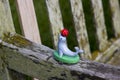 A childs plastic toy seal with a ball that was left on the arm of a public bench Royalty Free Stock Photo