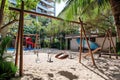 Childs Play Area With Swings and Slide, Fun and Safe Outdoor Playground for Kids, A beach-side playground with swings, sand play Royalty Free Stock Photo