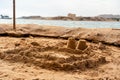 Childs sand castle on sandy beach near the water Royalty Free Stock Photo