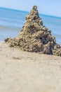 A Childs sand castle waiting for the ocean tide to come in to reclaim it