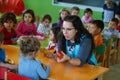 Teacher and childs during lunch time at Kindergarten in mallorca