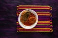 Chile Relleno and Caldillo Mexican food dish on Woven Tablecloth.