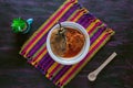 Chile Relleno and Caldillo Mexican food dish on Woven Tablecloth.