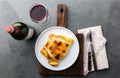 Chilean empanada served on wite plate with red wine. Top view Royalty Free Stock Photo