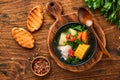 Chilean meat soup with pampkin, corn, fresh coriander and potatoes on old wooden table background. Cazuela. Latinamerican food. Royalty Free Stock Photo