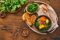 Chilean meat soup with pampkin, corn, fresh coriander and potatoes on old wooden table background. Cazuela. Latinamerican food