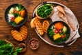 Chilean meat soup with pampkin, corn, fresh coriander and potatoes on old wooden table background. Cazuela. Latinamerican food