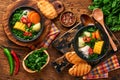 Chilean meat soup with pampkin, corn, fresh coriander and potatoes on old wooden table background. Cazuela. Latinamerican food