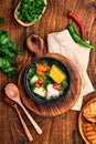 Chilean meat soup with pampkin, corn, fresh coriander and potatoes on old wooden table background. Cazuela. Latinamerican food Royalty Free Stock Photo