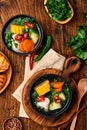 Chilean meat soup with pampkin, corn, fresh coriander and potatoes on old wooden table background. Cazuela. Latinamerican food