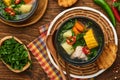 Chilean meat soup with pampkin, corn, fresh coriander and potatoes on old wooden table background. Cazuela. Latinamerican food Royalty Free Stock Photo