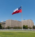 Chileans walking near the giant flag on Avenida La Alameda with the citizenship Square, in downtown Santiago de Chile. Chile