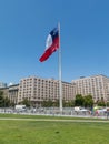 Chileans walking near the giant flag on Avenida La Alameda with