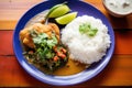 chiles rellenos served with rice and beans on a plate