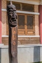 Two Jangseung totems in front of building