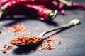 Chili. Chili peppers. Several dried chilli peppers and crushed peppers on an old spoon spilled around. Mexican ingredients Royalty Free Stock Photo