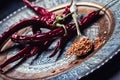 Chili. Chili peppers. Several dried chilli peppers and crushed peppers on an old spoon spilled around. Mexican ingredients Royalty Free Stock Photo