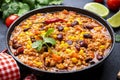 Chili con carne with beef, red beans, paprika, sweet corn and hot peppers in tomato sauce, spicy tex-mex dish in frying pan, black Royalty Free Stock Photo