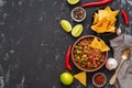 Chili con carne on a black concrete background, space for text.Mexican food, top view. Royalty Free Stock Photo