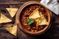 chili con carne in a bowl with tortilla chips