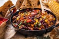 Chili con carne in a clay bowl on a concrete or stone rustic background- traditional dish of mexican cuisine.Top view Royalty Free Stock Photo