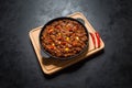 Chili con carne in frying pan on dark background. Texas chili. Royalty Free Stock Photo