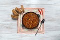 Chili con carne in frying pan on dark background. Texas chili. Royalty Free Stock Photo