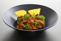 Chili con carne meal in a rustic bowl. Traditional dish of mexican cuisine with kidney beans, minced meat, parsley and tortilla ch Royalty Free Stock Photo