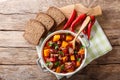 Chili con carne with pumpkin closeup in the pan. horizontal top