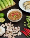 Chili paste thai language Nam prik kapi in a white bowl with ingredients and Fried steam mackerel on the table