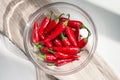 Chili pepper in a bowl on a white table Royalty Free Stock Photo